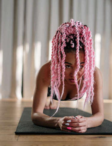 The image shows a woman doing a plank