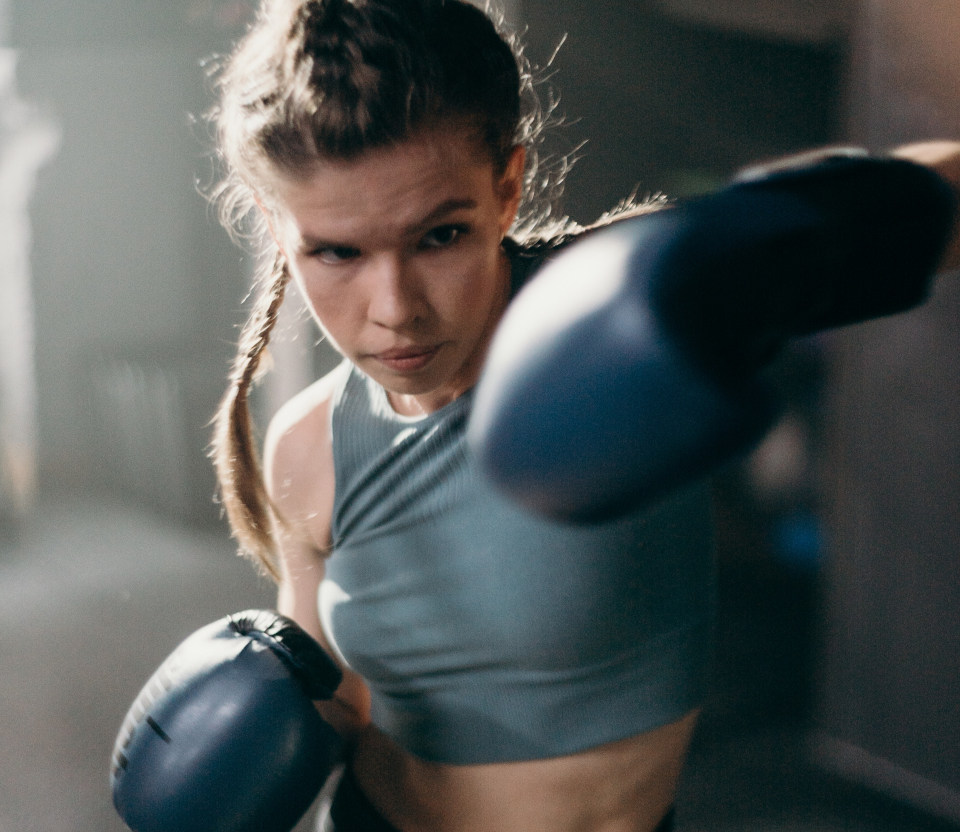 The image shows a girl boxing.