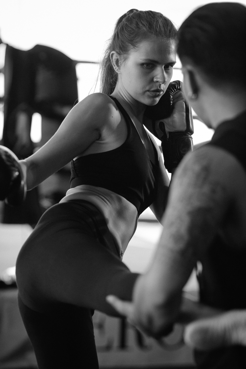 The image shows a girl doing kickboxing.